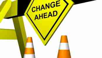 Change Ahead sign at road barrier